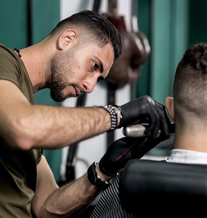 barber-trims-mustache-of-dark-haired-man-at-a-barbershop.jpg